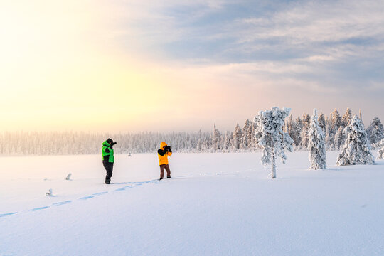 Photographers in the snowy boreal forest