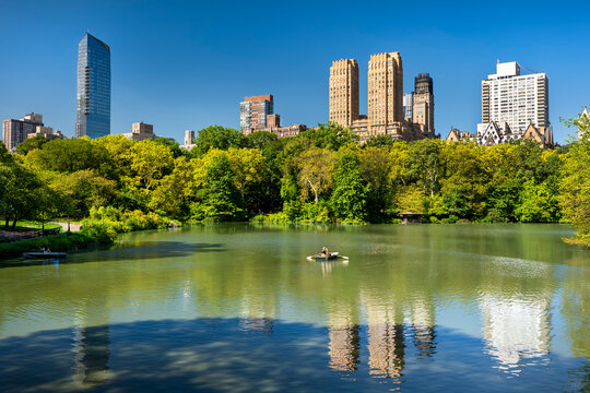 New York City Central Park people paddle boat on lake in Manhattan