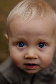 Smiling baby portrait with blue eyes in soft natural light