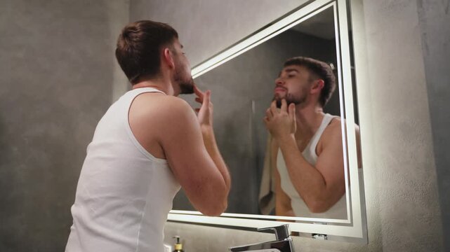 Man Applying Moisturizer to Face After Washing