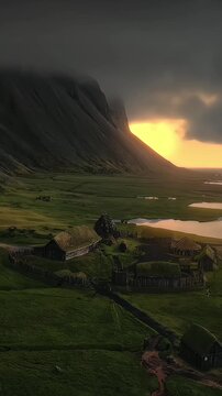 Stunning aerial view of traditional viking village with turf houses at sunset in iceland