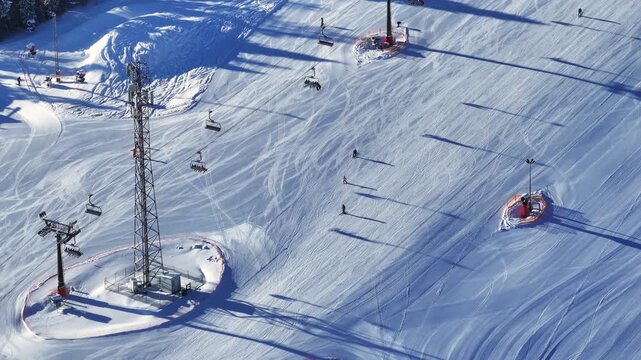 Winter ski resort with chairlifts and gondolas in snowy mountains