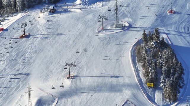 Winter ski resort with chairlifts and gondolas in snow-covered mountains