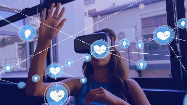 Animation of network of connections with icons over caucasian businesswoman using vr headset
