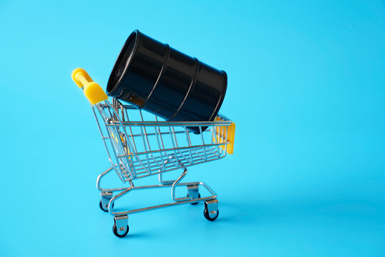 Oil drum in a shopping cart symbolizing commerce and global business
