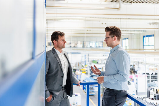 Business meeting in a modern production hall with professional discussion