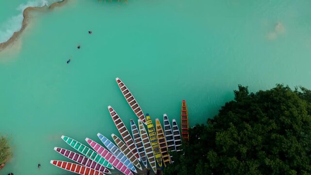 Explore El Meco Waterfall and the colorful boats in El Naranjo, San Luis Potosi, Mexico with lush tropical views