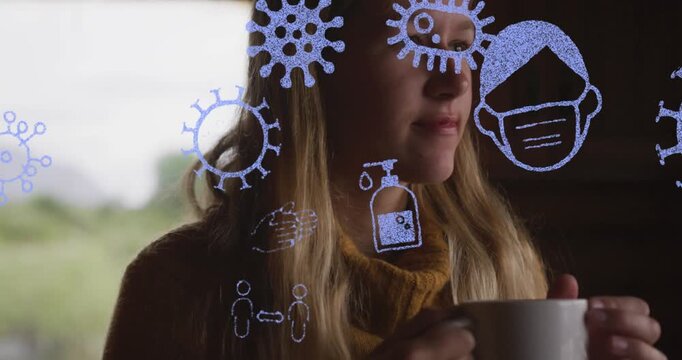 Animation of virus, mask, sanitizers vector icons moving over caucasian woman drinking coffee