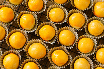 Closeup of freshly baked Nastar tarts, a cherished treat during festive seasons. These pastries are filled with sweet, tangy pineapple jam and finished with a signature glossy glaze.