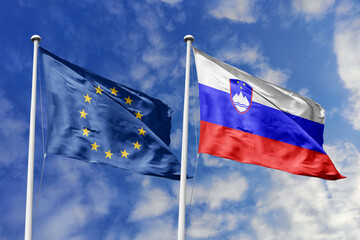 Waving flags of the European Union and Slovenia together on blue sky background. Official diplomatic relations, partnership and business concept.