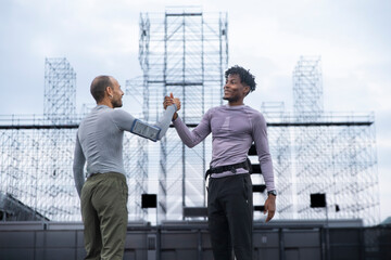 Athletes stretching and motivating each other during outdoor running training