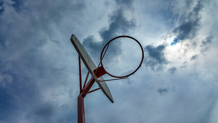 Low Angle View of Basketball Hoop Under Cloudy Sky