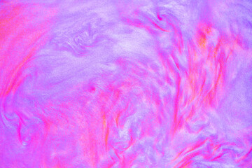 Fototapeta premium Shimmering multicolor abstract background. Liquid glitter paint texture waves and swirls. Beautiful shiny blue and pink glitter texture. Metallic paint close-up as a holiday background.