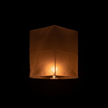 Glowing Sky Lantern Floating in the Dark Night