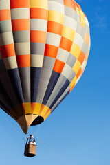 Obraz premium Close Up Hot Air Balloon Flying in Clear Blue Sky With Copy Space