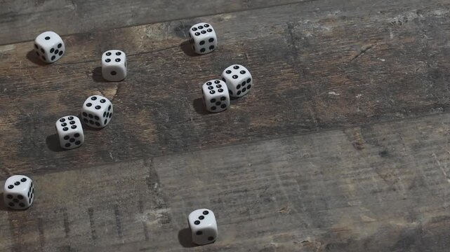 Mass of dice thrown on wooden table during game session