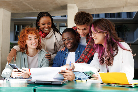 Diverse group of students collaborating outdoors - Powered by Adobe