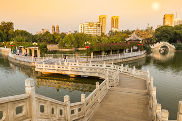 Sunset over the bridges of the peoples park in Tianjin, China
