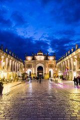 Illuminated city gate at night on the Stanislas square in Nancy, France