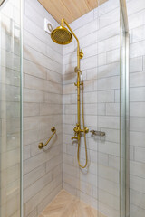 Vintage brass shower set in a rustic bathroom interior