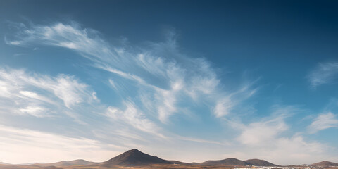 Wispy clouds drift over a vast sky above the arid landscape of Fuerteventura nature minimal