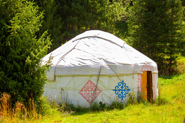 Yurt. National ancient house of the peoples of Kazakhstan and Asian countries. National Housing. Yurts on the background of a green meadow and highlands.