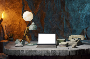 High-performance laptop on a prehistoric office desk