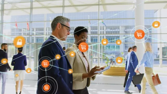 Computer application icons connecting with lines over multiracial coworkers discussing in corridor