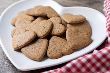 Heart-shaped gingerbread cookies on wooden table. Valentines day concept