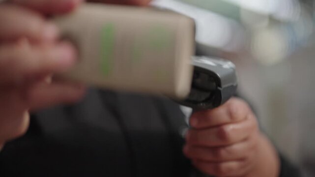 Partial blur shot of a person scanning a product using a handheld device