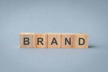 Word Brand on wooden blocks. Isolated on light blue or gray background.