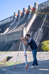 Blue collar worker is working at the dam.