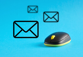 Wireless mouse sending and receiving email messages on blue background