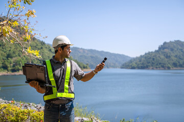 Blue collar worker is working at the dam.