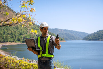 Blue collar worker is working at the dam.