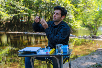 The environmentalist is testing a water Stream in the forest.