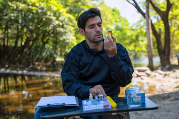 The environmentalist is testing a water Stream in the forest.