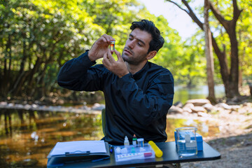 The environmentalist is testing a water Stream in the forest.