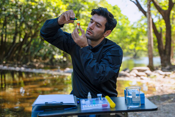 The environmentalist is testing a water Stream in the forest.