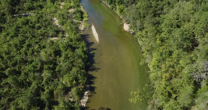 Flying Over The North Fork River Flowing Through The Dense Forest In Devils Backbone, Pottersville, Missouri, USA. - aerial shot