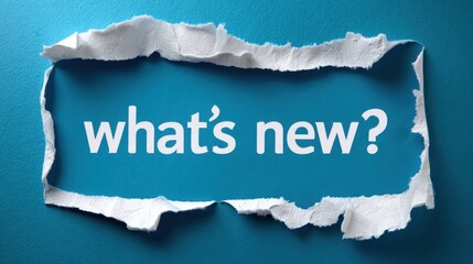 The torn paper revealing 'What's New?' message on vibrant blue background