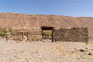 Traditional adobe houses standing in the middle of the Saudi Arabian desert, showcasing ancient earthen architecture adapted to extreme arid conditions. 