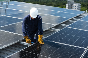 Engineer checking inspection solar cell on the roof.Technician installation solar panel on blue sky and white clouds background.Technology solar energy renewable and clean © arcyto