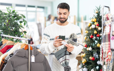 Man scans the QR code of the label on the hats to find out detailed information about the material...