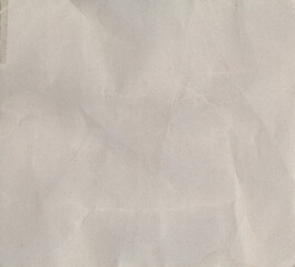Fototapeta premium Wrinkled Paper Texture: A close-up view of textured paper, the creases and folds create a delicate, abstract pattern, the soft lighting enhancing the gentle surface.
