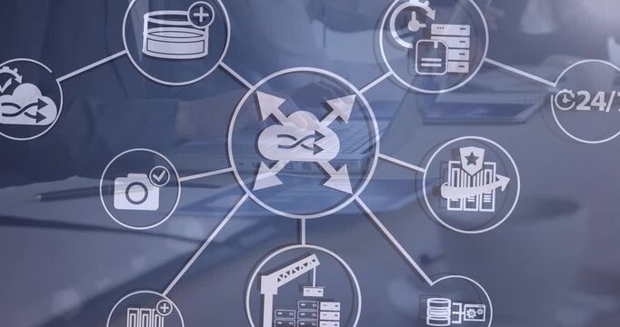 Animation of network of digital icons over mid section of businessman using laptop at office