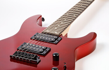 Red electric guitar body and neck on white background