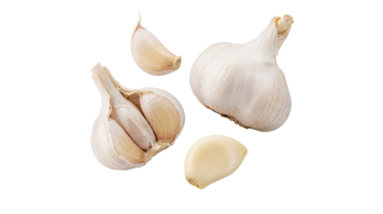 a composition of whole garlic bulbs and loose cloves scattered on a transparent background, highlighting the natural texture and form of this essential ingredient.