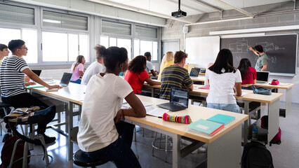 Diverse students learning in a high school classroom lecture