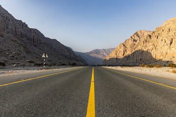 Mountain road background with a stunning view of Jebel Jais under a cloudy sky, a beautiful travel destination in Ras Al Khaimah.